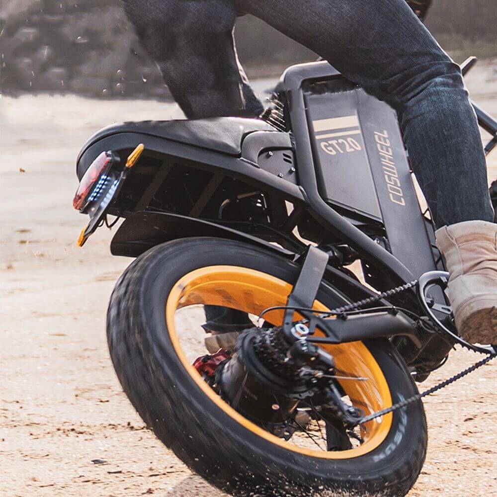 Black Coswheel GT20 1000W 48V adventure ebike with 20 inch fat tires and orange accents. outdoors